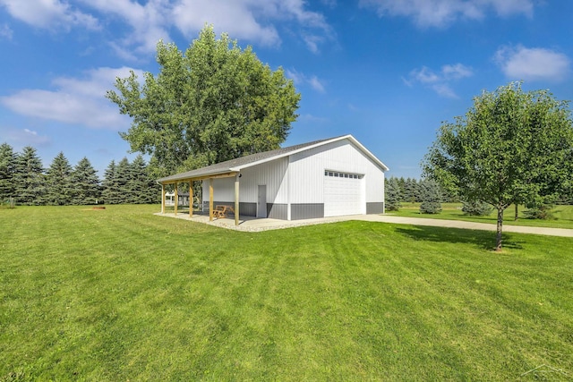 5353 N Graham Rd, Freeland, MI 48623 - rear view of property featuring a lawn, a garage, and an outdoor structure