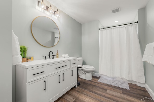 5353 N Graham Rd, Freeland, MI 48623 - bathroom with wood finished floors, toilet, baseboards, vanity, and recessed lighting