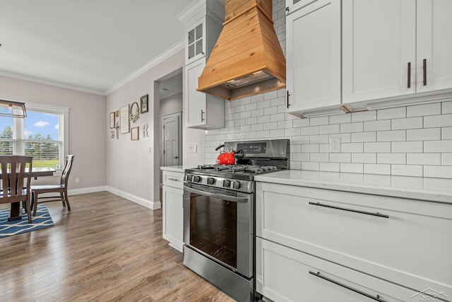5353 N Graham Rd, Freeland, MI 48623 - kitchen featuring stainless steel gas range, premium range hood, ornamental molding, backsplash, and light countertops
