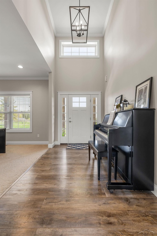 5353 N Graham Rd, Freeland, MI 48623 - foyer entrance with a chandelier, crown molding, dark wood finished floors, baseboards, and healthy amount of natural light