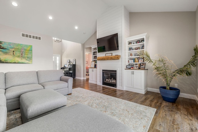 5353 N Graham Rd, Freeland, MI 48623 - living room featuring baseboards, recessed lighting, wood finished floors, a large fireplace, and high vaulted ceiling