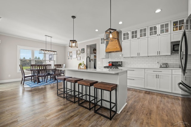 5353 N Graham Rd, Freeland, MI 48623 - kitchen featuring stainless steel appliances, custom range hood, light countertops, backsplash, and ornamental molding