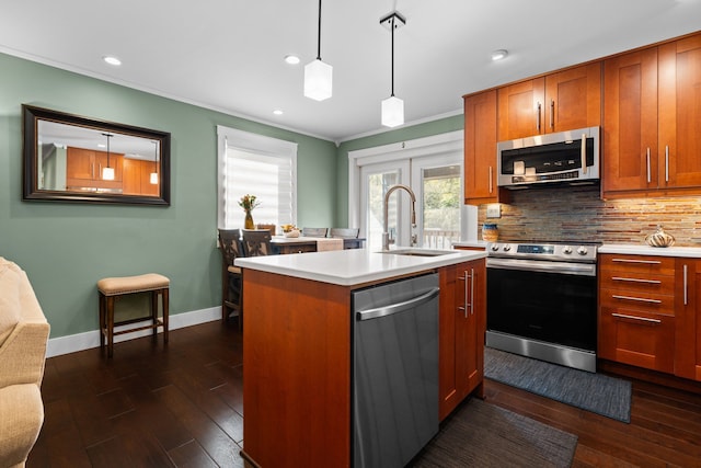 kitchen with appliances with stainless steel finishes, a sink, light countertops, decorative backsplash, and brown cabinetry