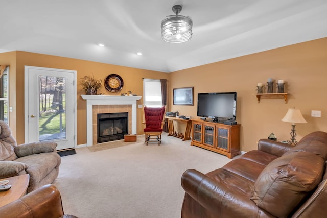 9100 Boggie Dr Unit 159, Canadian Lakes, MI 49346 - carpeted living area featuring a tile fireplace, vaulted ceiling, baseboards, and recessed lighting