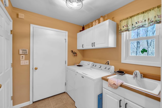 9100 Boggie Dr Unit 159, Canadian Lakes, MI 49346 - laundry room featuring cabinet space, separate washer and dryer, light tile patterned flooring, and baseboards