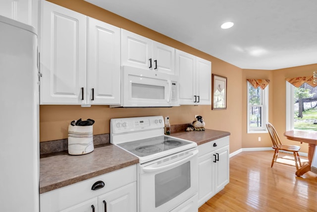 9100 Boggie Dr Unit 159, Canadian Lakes, MI 49346 - kitchen featuring white appliances, baseboards, light wood finished floors, white cabinets, and recessed lighting