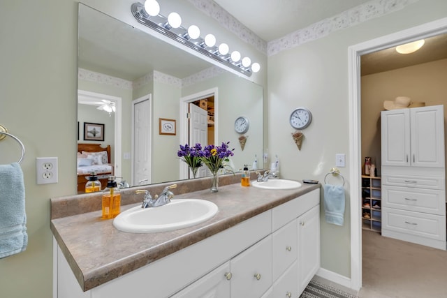 9100 Boggie Dr Unit 159, Canadian Lakes, MI 49346 - ensuite bathroom with double vanity and a ceiling fan