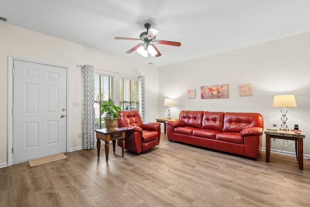 living area with light wood-style flooring, ceiling fan, and baseboards