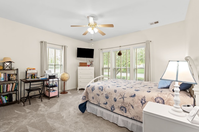 bedroom with multiple windows, carpet, and ceiling fan