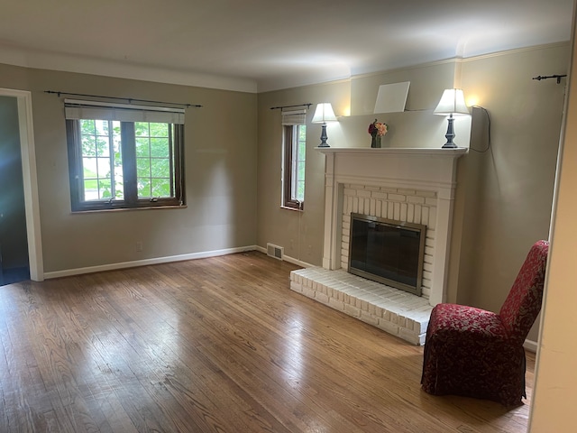 532 Saint Clair St, Grosse Pointe, MI 48230 - living area with healthy amount of natural light, wood finished floors, baseboards, and a brick fireplace