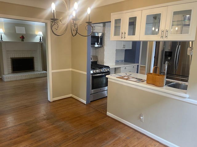 532 Saint Clair St, Grosse Pointe, MI 48230 - kitchen featuring stainless steel appliances, baseboards, dark wood-type flooring, light countertops, and glass insert cabinets