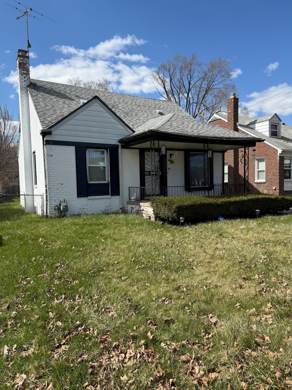 bungalow-style house featuring brick siding, a chimney, and a porch