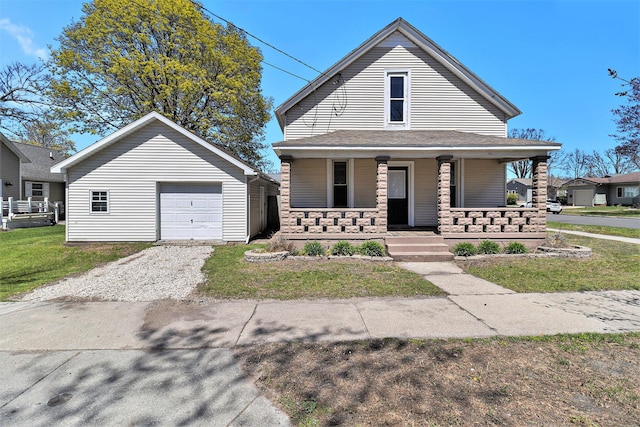 601 N Rath Ave, Ludington, MI 49431 - view of front of home featuring a porch, an outdoor structure, a garage, a front yard, and driveway