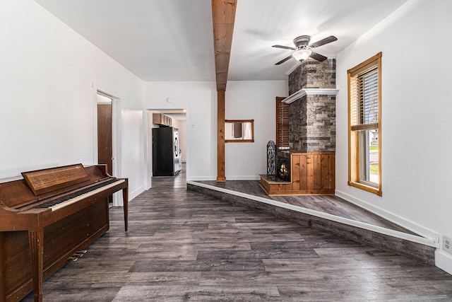 601 N Rath Ave, Ludington, MI 49431 - living room featuring ceiling fan, a fireplace, dark wood-type flooring, and baseboards