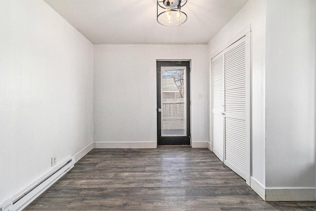601 N Rath Ave, Ludington, MI 49431 - entryway featuring a baseboard radiator, a chandelier, dark wood-style floors, and baseboards