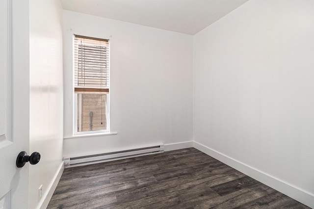 601 N Rath Ave, Ludington, MI 49431 - empty room featuring baseboard heating, dark wood-style flooring, and baseboards