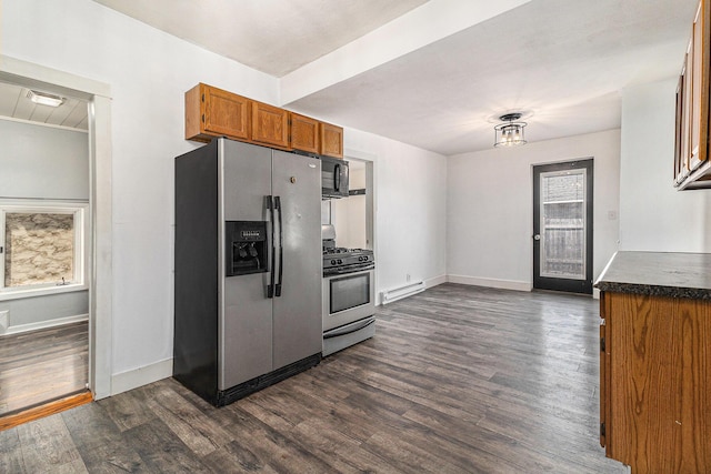 601 N Rath Ave, Ludington, MI 49431 - kitchen with appliances with stainless steel finishes, brown cabinets, a baseboard heating unit, dark wood-style floors, and dark countertops