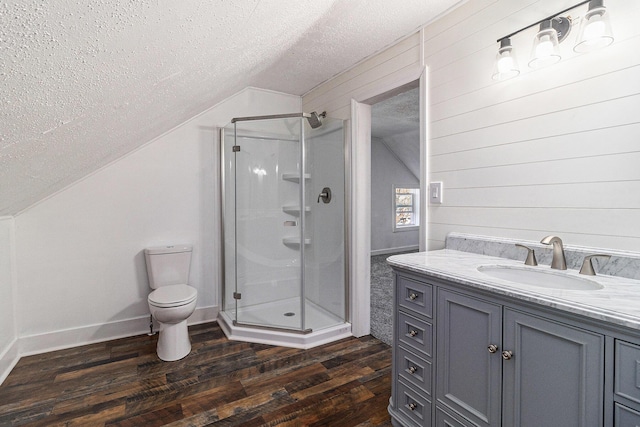 601 N Rath Ave, Ludington, MI 49431 - full bathroom with lofted ceiling, a textured ceiling, a stall shower, wood finished floors, and vanity