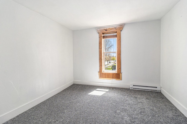 601 N Rath Ave, Ludington, MI 49431 - empty room with baseboard heating, carpet flooring, and baseboards