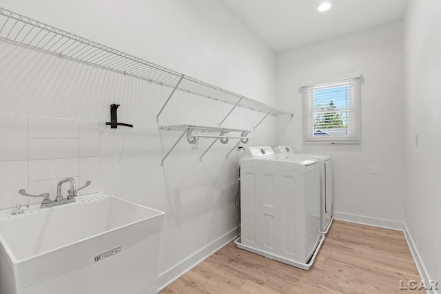 4189 Evergreen Rd, Adrian, MI 49221 - laundry room with washing machine and clothes dryer, light wood finished floors, and baseboards