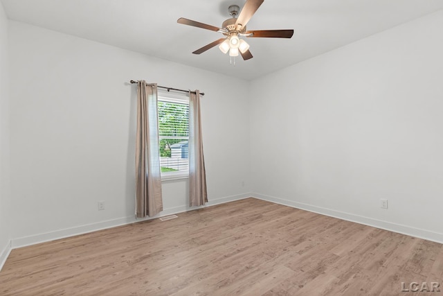 4189 Evergreen Rd, Adrian, MI 49221 - spare room featuring light wood-style floors, a ceiling fan, and baseboards