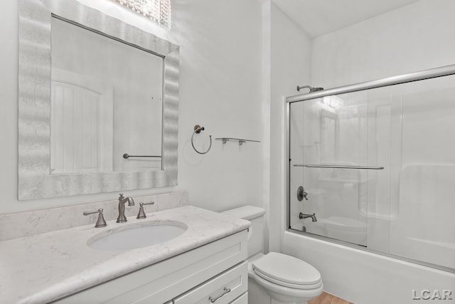 4189 Evergreen Rd, Adrian, MI 49221 - bathroom with toilet, vanity, and bath / shower combo with glass door