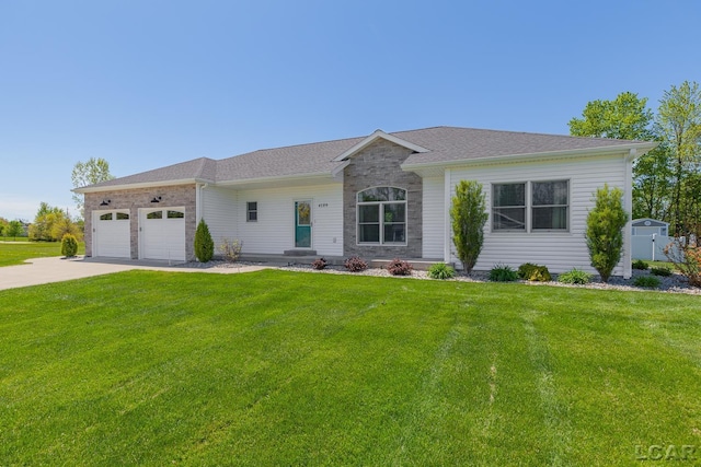 4189 Evergreen Rd, Adrian, MI 49221 - ranch-style house featuring a front lawn, a garage, driveway, and stone siding