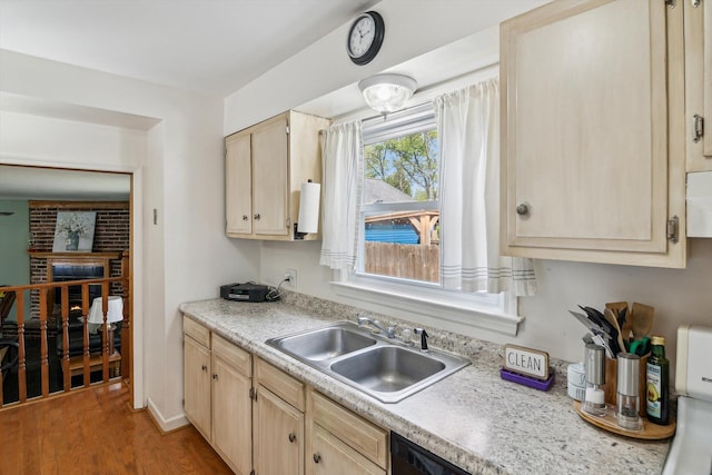 kitchen featuring a sink, light brown cabinets, light countertops, and wood finished floors