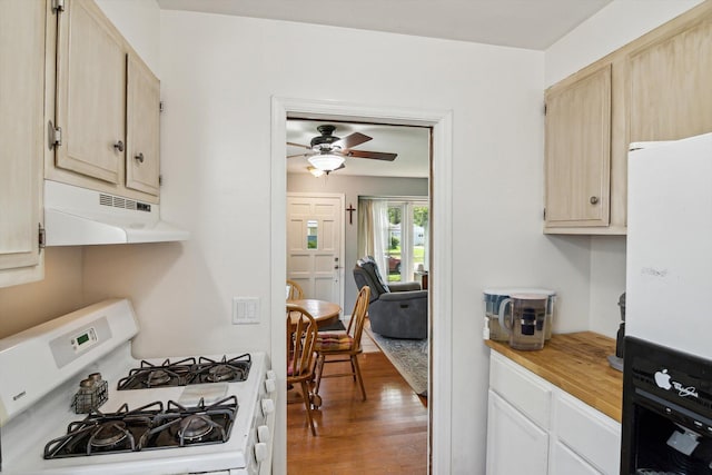 kitchen featuring white appliances, under cabinet range hood, light countertops, ceiling fan, and wood finished floors
