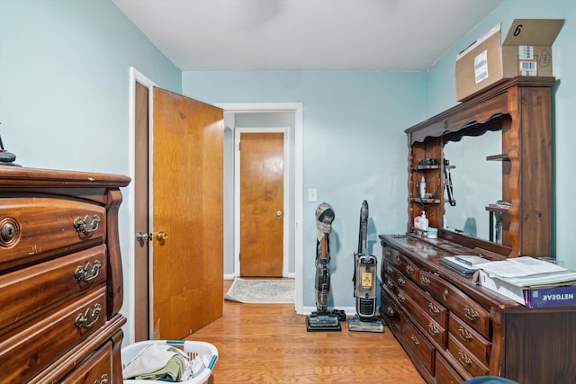 bedroom with light wood-type flooring and baseboards