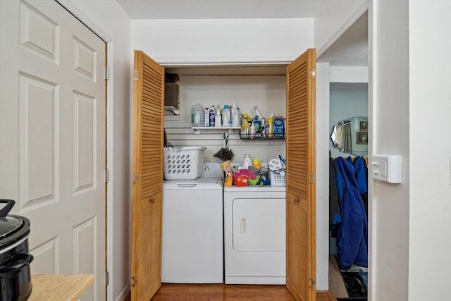 laundry area with separate washer and dryer and light wood-style floors