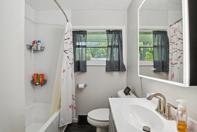bathroom featuring plenty of natural light, a textured ceiling, toilet, vanity, and shower / tub combo