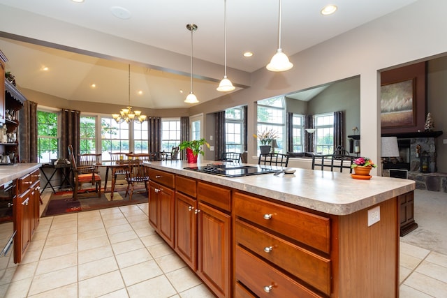 8216 Leonard Dr, Holly, MI 48442 - kitchen featuring light tile patterned floors, lofted ceiling, a chandelier, light countertops, and black electric cooktop