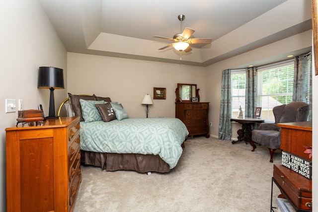 8216 Leonard Dr, Holly, MI 48442 - bedroom featuring a raised ceiling, light colored carpet, baseboards, and a ceiling fan