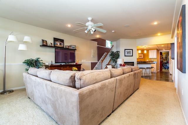 8216 Leonard Dr, Holly, MI 48442 - living area featuring light colored carpet, stairs, a ceiling fan, baseboards, and recessed lighting