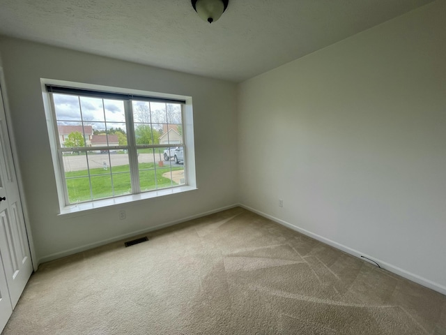unfurnished room with baseboards and carpet flooring