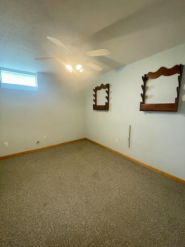 empty room with carpet floors, baseboards, and a ceiling fan