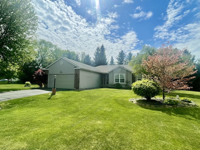 view of side of property with concrete driveway, an attached garage, a yard, and brick siding