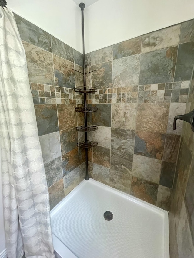 bathroom with a tile shower