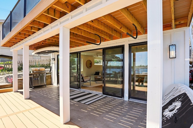 wooden deck featuring area for grilling and fence