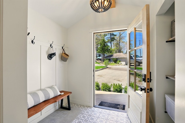 mudroom featuring vaulted ceiling, a chandelier, and baseboards