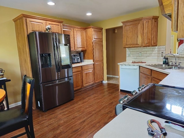 24864 Christina Dr, Flat Rock, MI 48134 - kitchen featuring appliances with stainless steel finishes, a sink, light countertops, dark wood finished floors, and backsplash