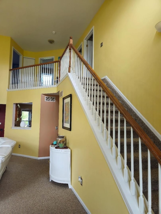24864 Christina Dr, Flat Rock, MI 48134 - stairway with a high ceiling, baseboards, and carpet flooring