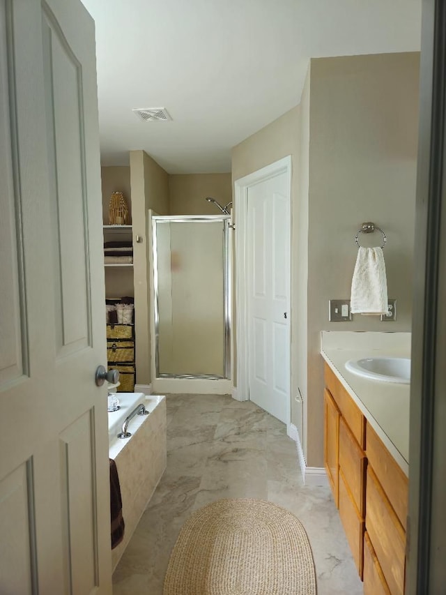 24864 Christina Dr, Flat Rock, MI 48134 - full bathroom featuring a shower stall, a bath, marble finish flooring, and vanity