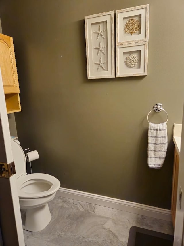 24864 Christina Dr, Flat Rock, MI 48134 - bathroom with baseboards, marble finish floors, and toilet