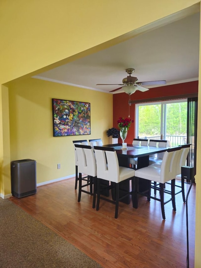 24864 Christina Dr, Flat Rock, MI 48134 - dining space with crown molding, wood finished floors, a ceiling fan, and baseboards