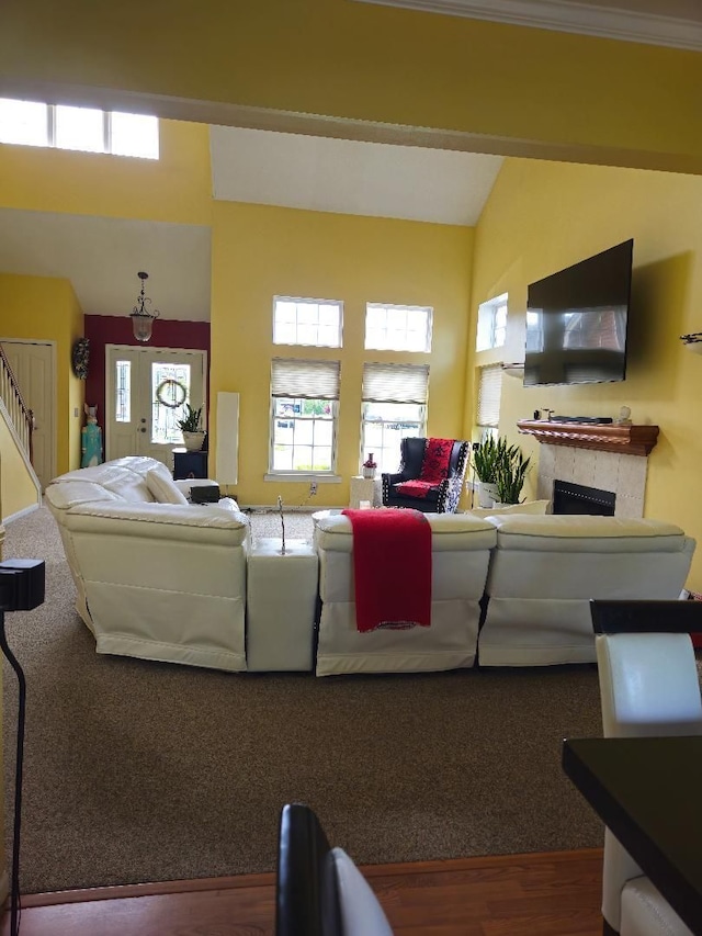 24864 Christina Dr, Flat Rock, MI 48134 - living room featuring stairway, wood finished floors, a fireplace, and a high ceiling