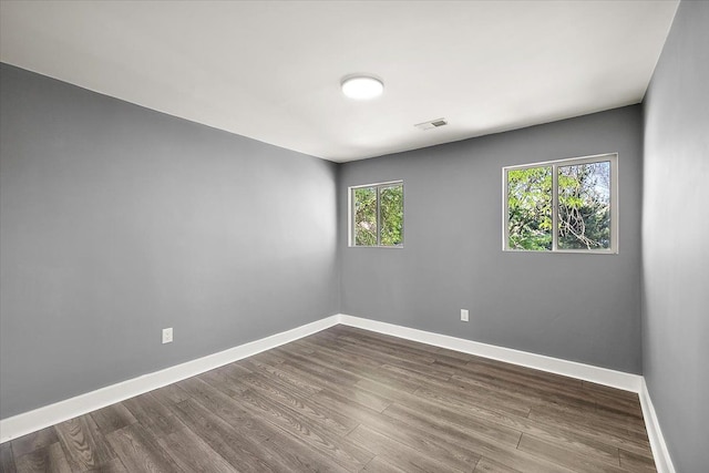 13519 Mansfield St, Detroit, MI 48227 - empty room featuring baseboards, healthy amount of natural light, and dark wood-type flooring
