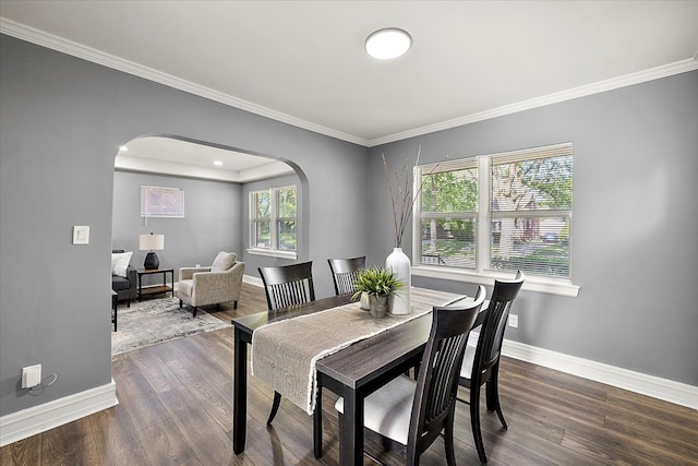 13519 Mansfield St, Detroit, MI 48227 - dining area featuring arched walkways, crown molding, baseboards, and wood finished floors