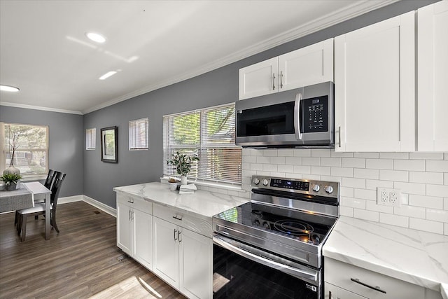 13519 Mansfield St, Detroit, MI 48227 - kitchen featuring appliances with stainless steel finishes, ornamental molding, decorative backsplash, white cabinets, and baseboards